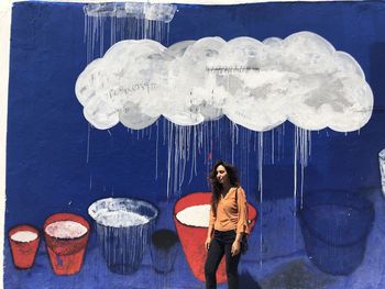 Digital composite image of woman standing against blue sky