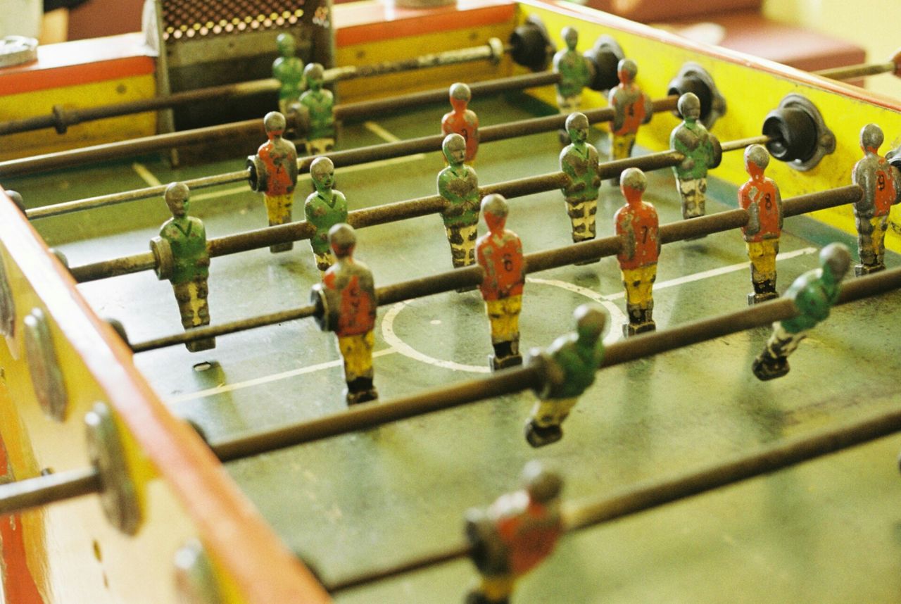 selective focus, indoors, hanging, focus on foreground, in a row, men, day, railing, childhood, close-up, variation, green color, high angle view, lifestyles, side by side, leisure activity, sport, padlock, metal