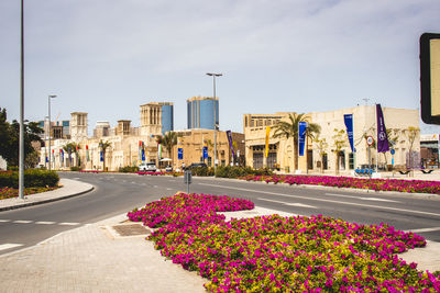 View of street amidst buildings in city against sky