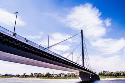 Low angle view of suspension bridge against sky