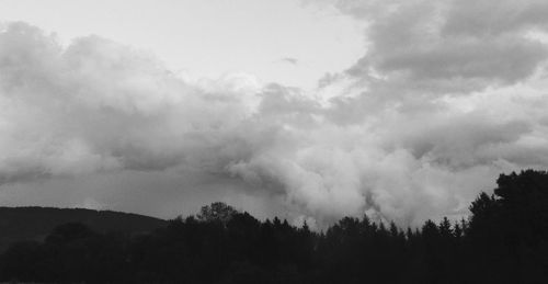Scenic view of mountains against cloudy sky