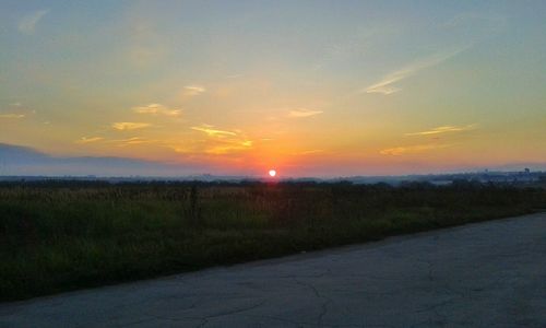 Scenic view of field against sky during sunset