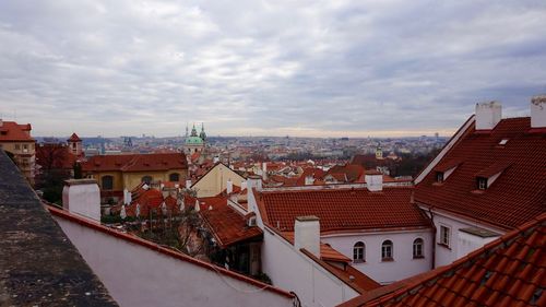 High angle shot of townscape against cloudy sky