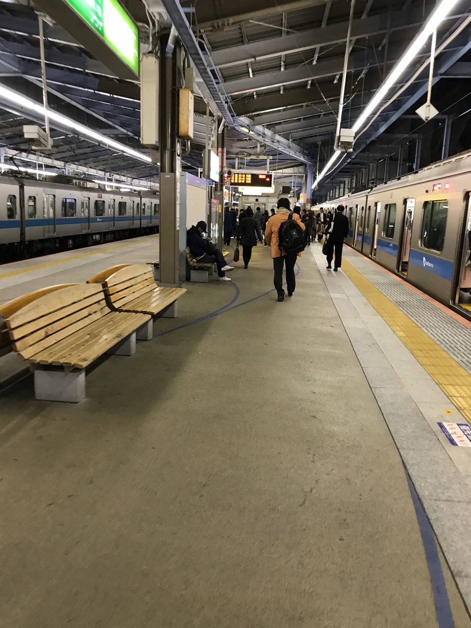 transportation, railroad station platform, public transportation, railroad station, indoors, real people, train - vehicle, men, rail transportation, mode of transport, women, illuminated, large group of people, built structure, lifestyles, day, people