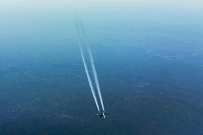 Aerial view of vapor trail over landscape