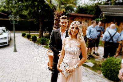 Portrait of smiling young couple standing outdoors