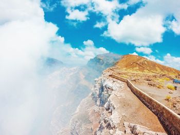 Scenic view of mountains against cloudy sky