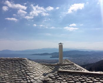 Lighthouse by sea against sky