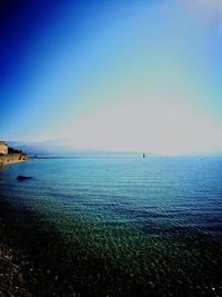 Scenic view of sea against clear blue sky