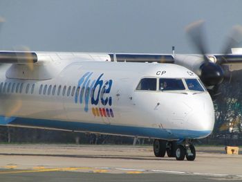 Airplane on runway against sky