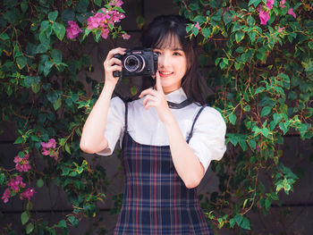 Portrait of teenage girl photographing