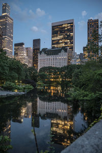 Reflection of illuminated buildings in city at night