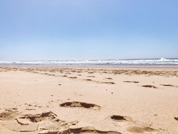 Scenic view of beach against clear sky