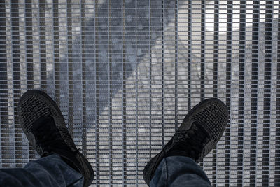 Low section of person on metal grate