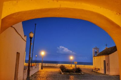 Empty pathway against calm blue sea