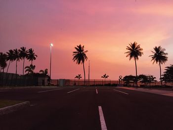 Silhouette palm trees against sky during sunset