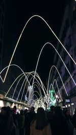 Low angle view of illuminated ferris wheel at night