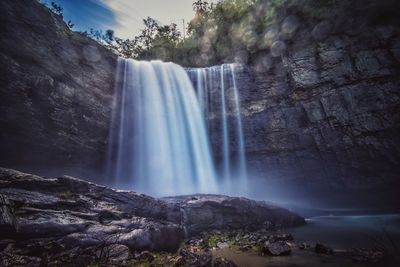 Low angle view of waterfall in forest