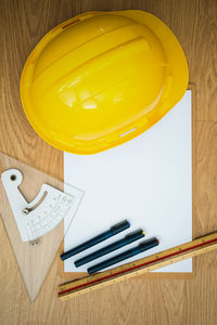 High angle view of yellow light bulb on table