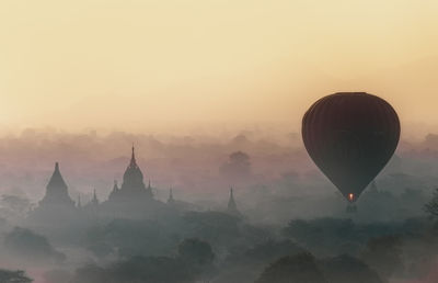 Hot air balloons against sky during sunset