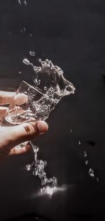 Close-up of hand holding water splashing