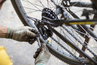 Close-up of man with bicycle on rope