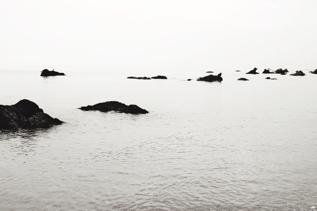 water, sea, clear sky, copy space, tranquility, tranquil scene, transportation, waterfront, nautical vessel, scenics, horizon over water, beauty in nature, mode of transport, nature, boat, idyllic, calm, rock - object, rippled, outdoors