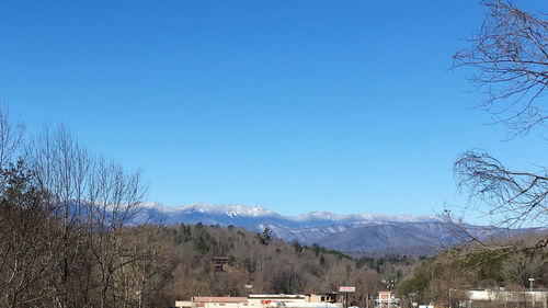 Scenic view of mountains against clear blue sky