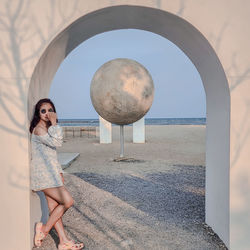 Portrait of woman standing at beach