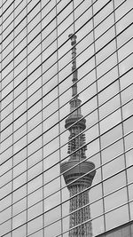 Low angle view of glass building against sky