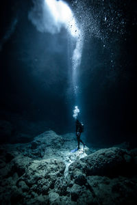 Man surfing in sea against sky