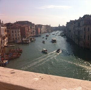 Boats in canal with buildings in background