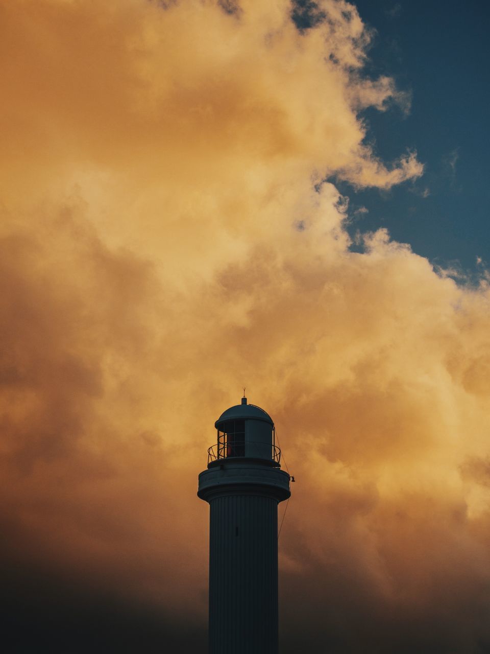 lighthouse, sky, architecture, built structure, building exterior, low angle view, cloud - sky, guidance, sunset, tower, protection, orange color, cloudy, direction, safety, cloud, security, weather, high section, outdoors