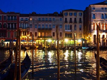 Reflection of buildings in canal at night