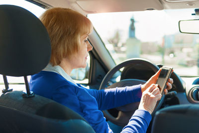 Portrait of man sitting in car