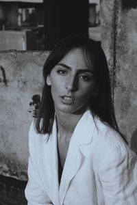 Portrait of young woman wearing blazer outdoors