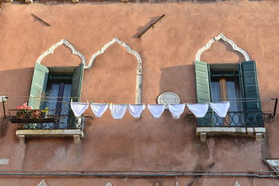 Low angle view of panties hanging on clothesline against building