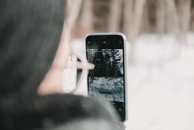 Woman photographing through smart phone