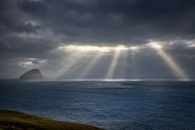 Sunlight streaming through sea against sky