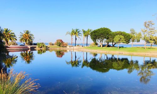 Scenic view of lake against clear blue sky