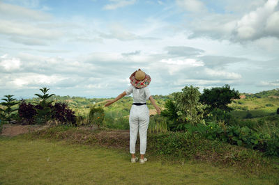 Full length of man standing on field against sky