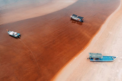 High angle view of boats on sand at beach