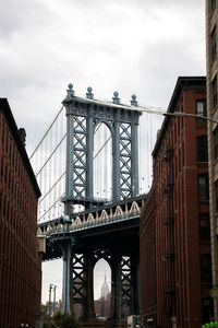 Low angle view of bridge against sky in city