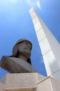 Low angle view of statue against blue sky