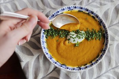 Woman eating pumpkin soup