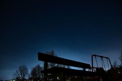 Low angle view of silhouette trees against sky at night