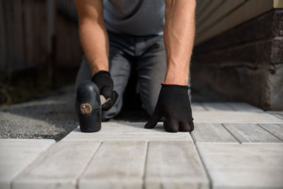 Low section of man working on wood