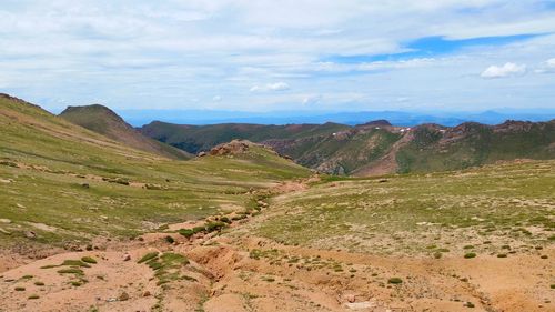 Scenic view of mountains against cloudy sky