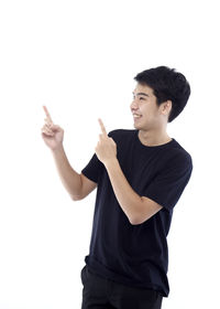 Young man looking away against white background