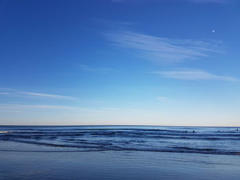 Scenic view of sea against blue sky